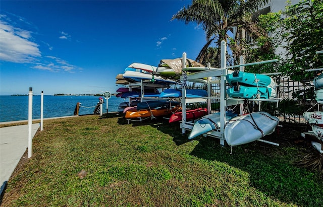 dock area featuring a water view and a yard