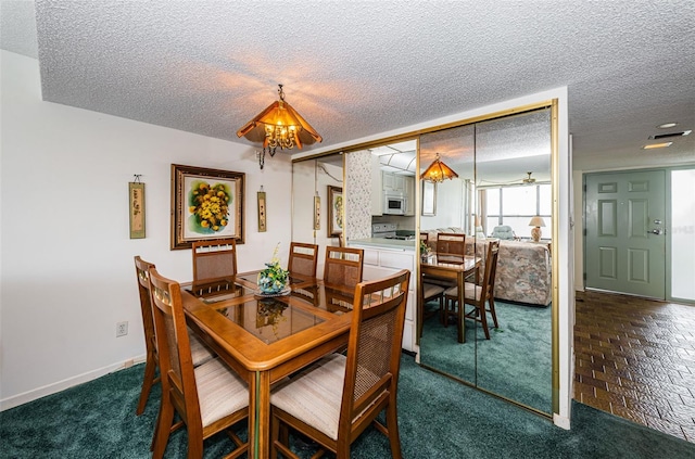 300 Woodette Dr Unit 202B, Dunedin, FL 34698 - dining area with a textured ceiling, a chandelier, and carpet