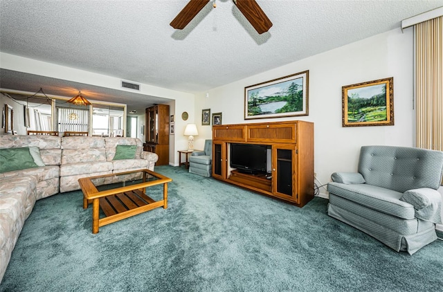 300 Woodette Dr Unit 202B, Dunedin, FL 34698 - living area with a ceiling fan, carpet floors, and a textured ceiling