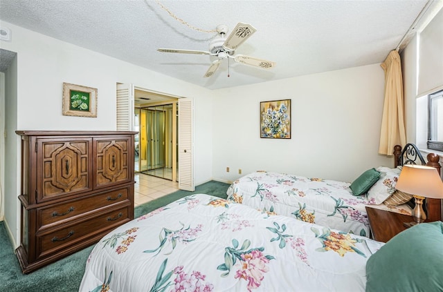 300 Woodette Dr Unit 202B, Dunedin, FL 34698 - bedroom with light colored carpet, a textured ceiling, and a ceiling fan