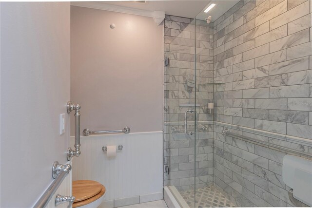 bathroom featuring tile patterned flooring, an enclosed shower, toilet, and crown molding