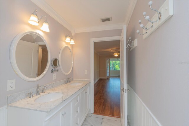 bathroom featuring ceiling fan, crown molding, hardwood / wood-style floors, and dual vanity