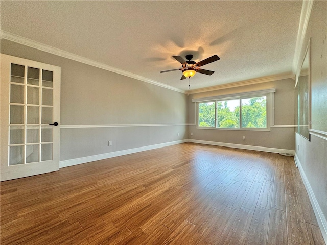 empty room featuring hardwood / wood-style floors, ornamental molding, and ceiling fan