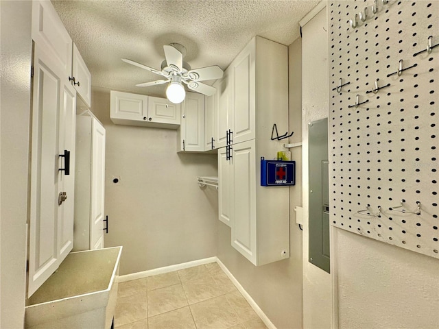 mudroom with a textured ceiling, ceiling fan, and light tile patterned flooring