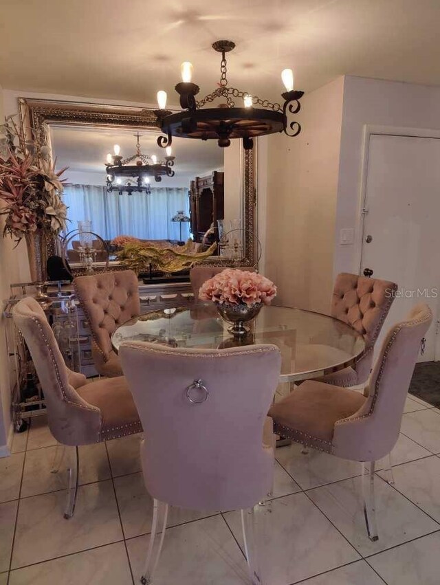 dining room featuring light tile patterned flooring and an inviting chandelier