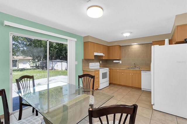 kitchen with decorative backsplash, sink, white appliances, and light tile patterned floors