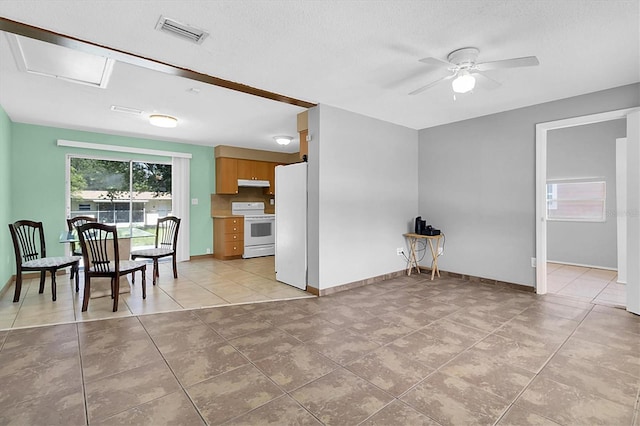 kitchen with ceiling fan, light tile patterned floors, and white appliances