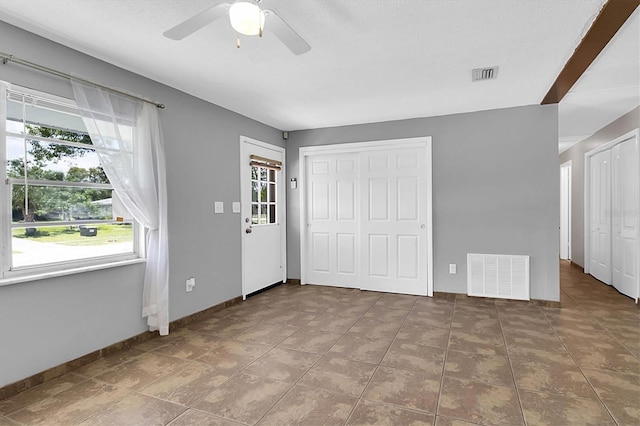 interior space with ceiling fan and tile patterned flooring