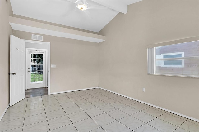 tiled empty room with lofted ceiling with beams