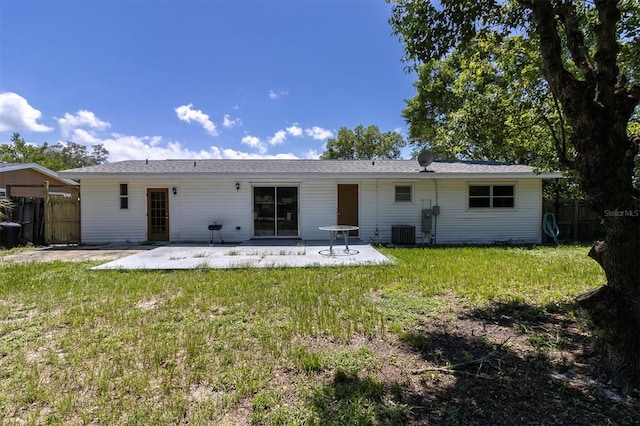 back of property featuring cooling unit, a yard, and a patio