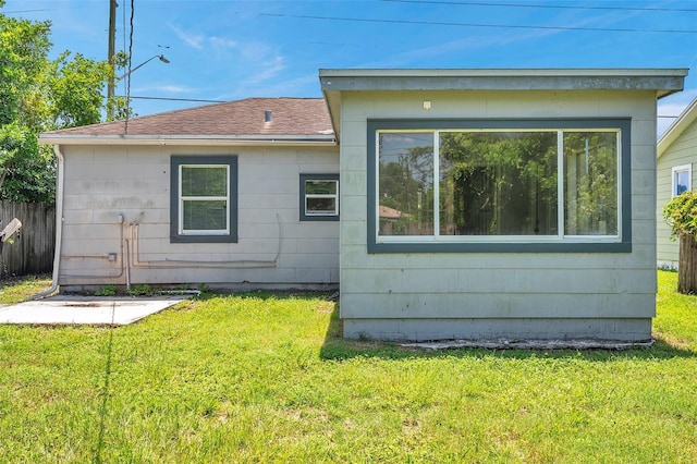 rear view of property with a lawn