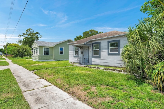 bungalow-style house with a front yard