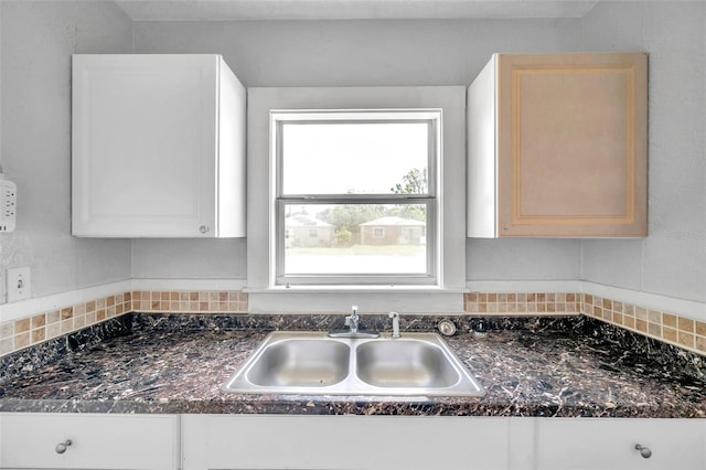 room details with sink, white cabinetry, and light brown cabinetry