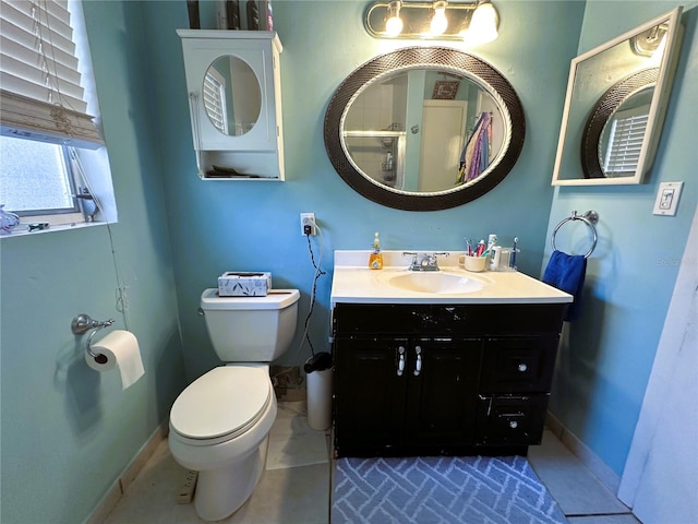 bathroom featuring vanity, toilet, and tile patterned floors