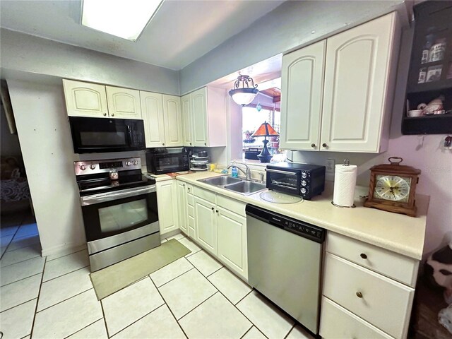 kitchen featuring appliances with stainless steel finishes, sink, and light tile patterned floors