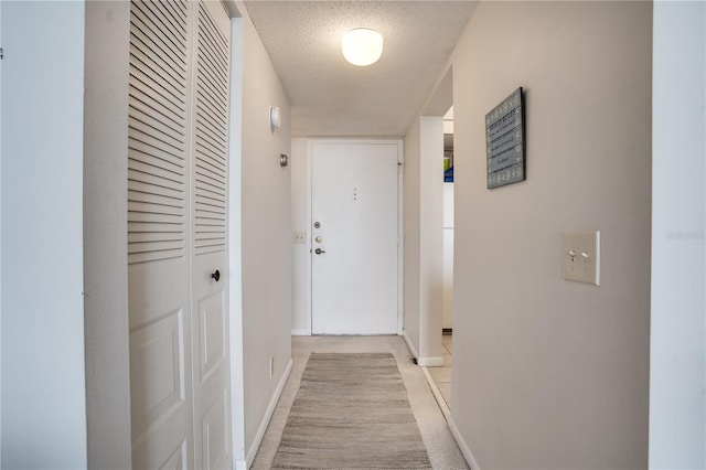 hallway with a textured ceiling