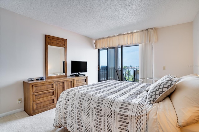 carpeted bedroom featuring a textured ceiling