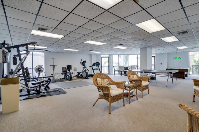 interior space with visible vents, a drop ceiling, and carpet flooring