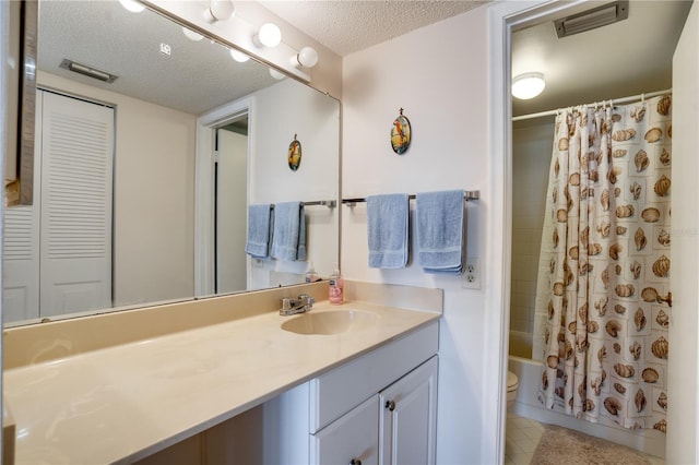 full bathroom with shower / tub combo with curtain, vanity, a textured ceiling, and toilet