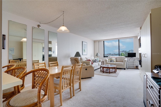 dining space with light carpet, a textured ceiling, and floor to ceiling windows