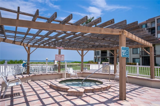 view of patio / terrace featuring a pergola and a hot tub