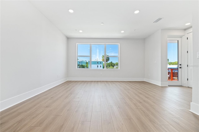 spare room featuring light wood-type flooring