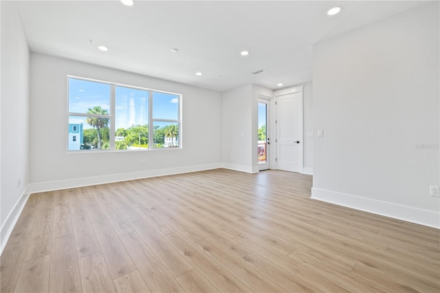 spare room with light hardwood / wood-style floors