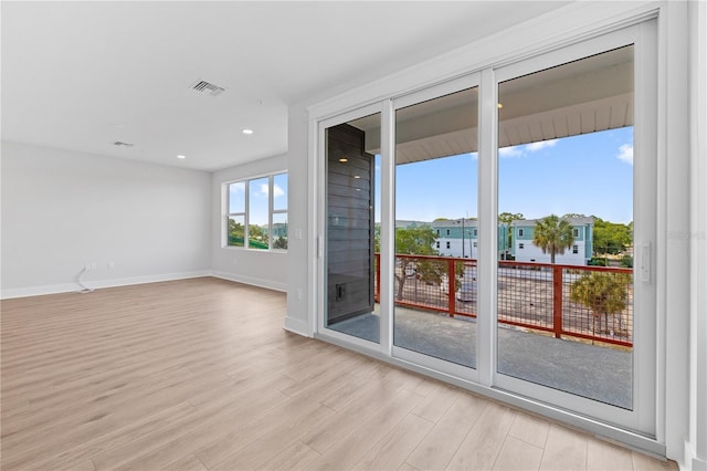 unfurnished room with light wood-type flooring