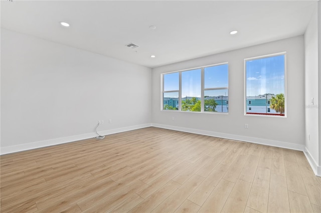 unfurnished room with light hardwood / wood-style floors