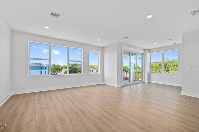 unfurnished room with light wood-type flooring