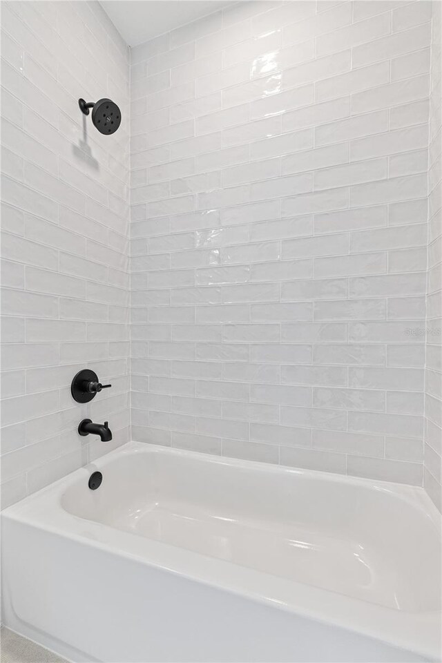 bathroom featuring tiled shower / bath