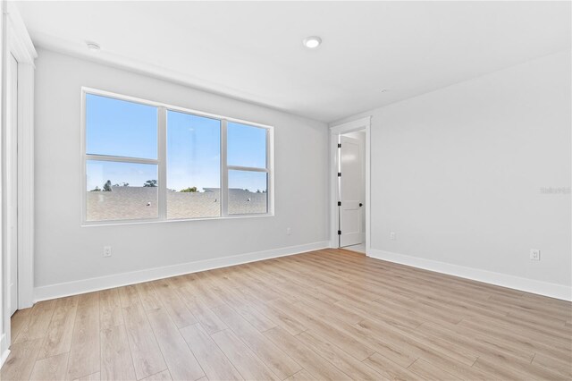 empty room with light hardwood / wood-style floors