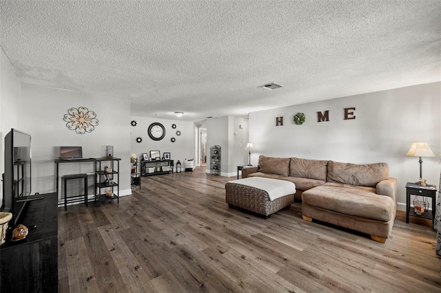 living room featuring hardwood / wood-style flooring and a textured ceiling