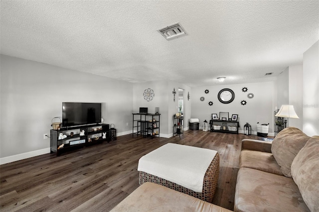 living room with dark wood-type flooring and a textured ceiling