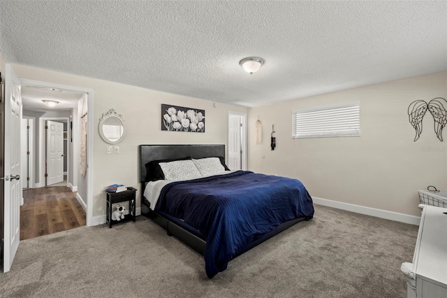 bedroom with wood-type flooring and a textured ceiling