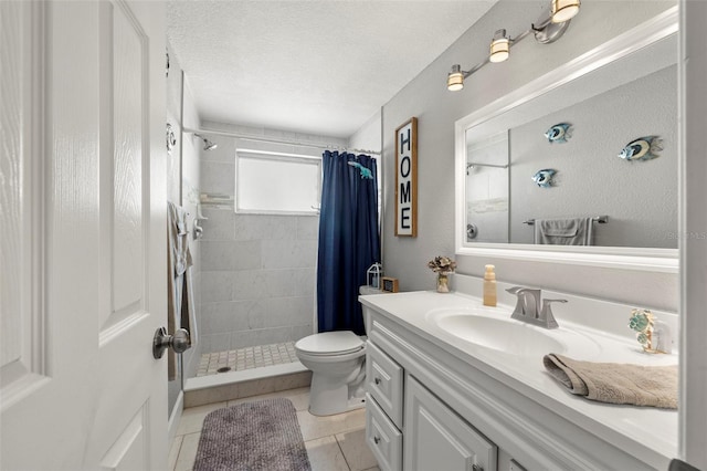 bathroom featuring a textured ceiling, tile patterned flooring, curtained shower, vanity, and toilet