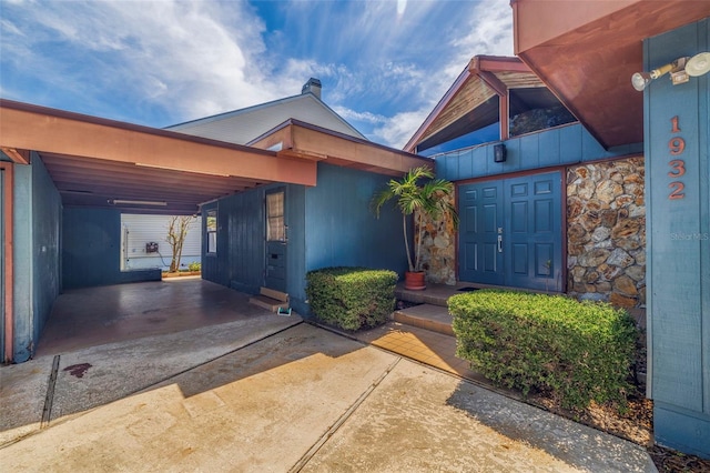 property entrance with a carport