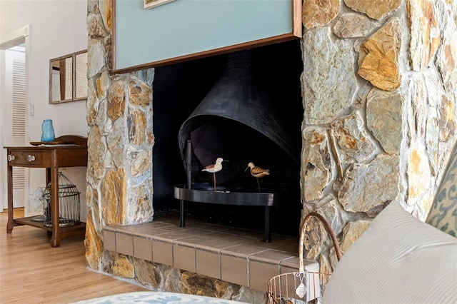 room details featuring hardwood / wood-style floors and a wood stove