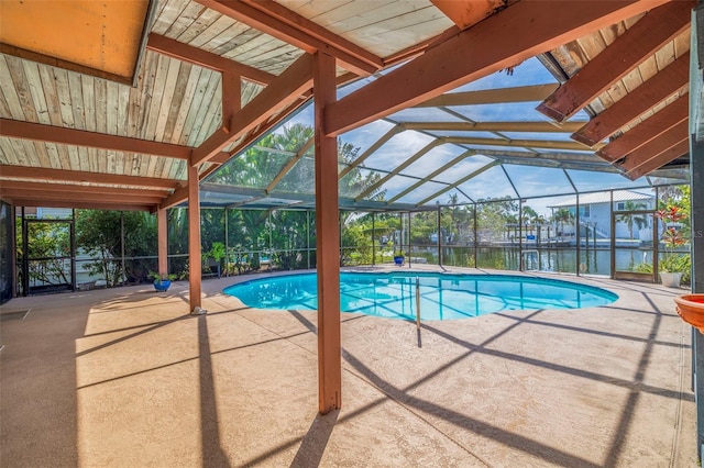 view of swimming pool with a water view, a lanai, and a patio area