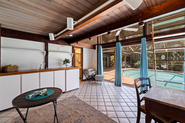 interior space featuring beamed ceiling, wood ceiling, sink, and a swimming pool