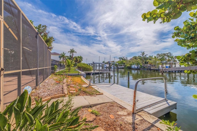 dock area featuring glass enclosure and a water view