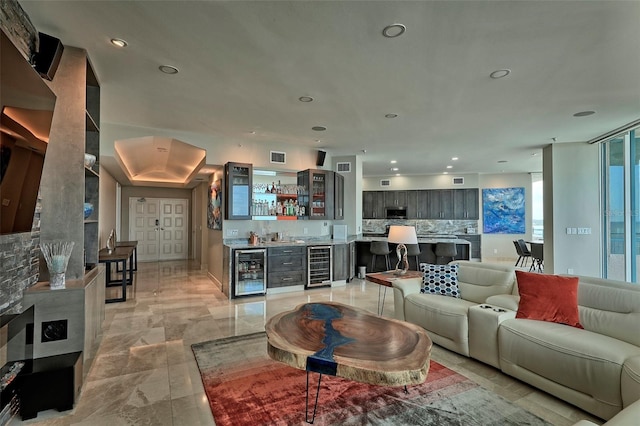 tiled living room featuring beverage cooler and bar area