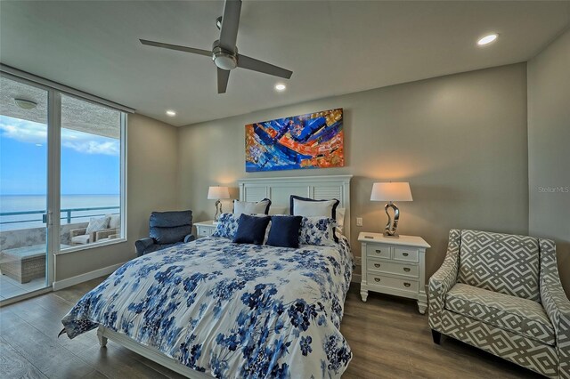 bedroom with ceiling fan, access to exterior, a water view, and wood-type flooring