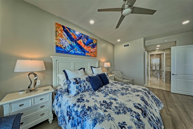 bedroom featuring ceiling fan, connected bathroom, and dark hardwood / wood-style floors