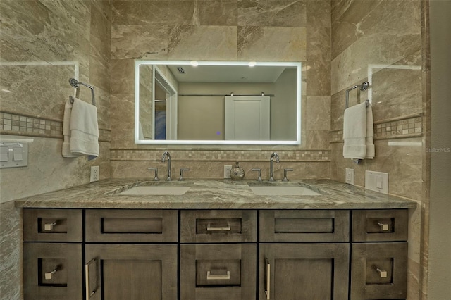 bathroom featuring tasteful backsplash, tile walls, and double sink vanity