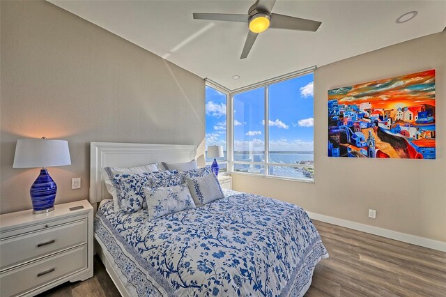 bedroom with ceiling fan and dark wood-type flooring