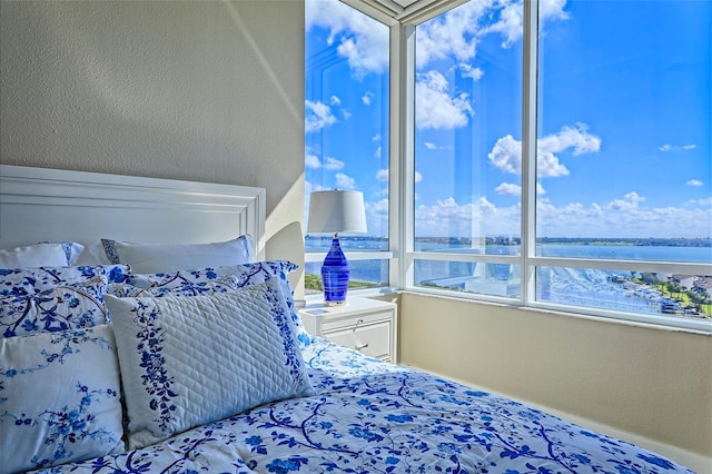 bedroom featuring a water view