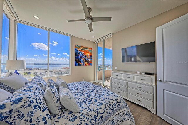 bedroom featuring ceiling fan, floor to ceiling windows, access to exterior, and wood-type flooring