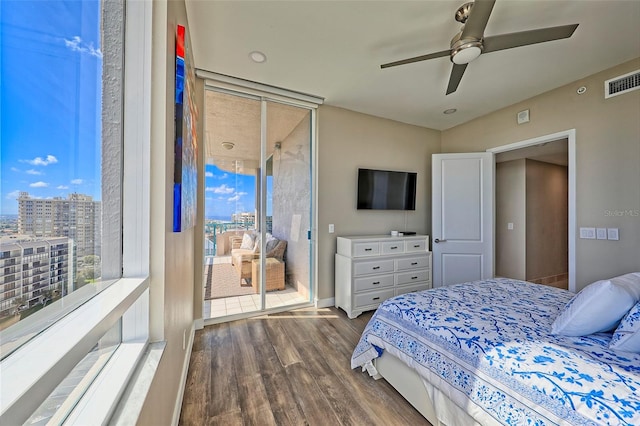 bedroom featuring floor to ceiling windows, dark wood-type flooring, and ceiling fan