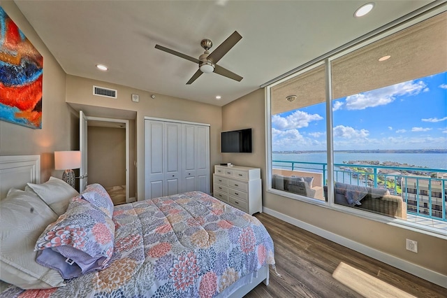 bedroom with wood-type flooring, a closet, and ceiling fan